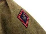a close up of a military uniform with a badge on it