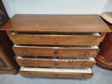 a wooden dresser with four drawers on top of it