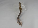 a metal object with a bird on it on a white surface