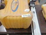 a large yellow tank sitting on a table with tools on it