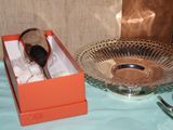 a silver spoon and a silver bowl on a table