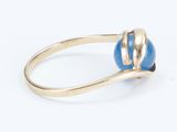 a close up of a ring with a blue stone on it