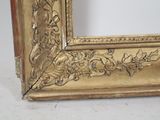 a picture of a gold picture frame on a white table