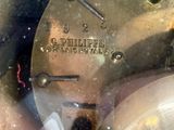 a close up of a clock that is on a table