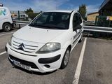 a small white car parked in a parking lot