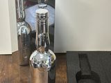 a bottle of wine next to a wine glass on a table