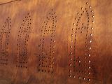 an image of a metal wall with holes on it