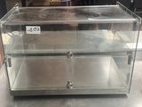 a glass display case with three drawers inside of it