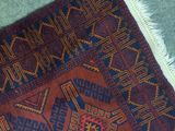 a cat that is laying on a rug on the floor