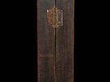an old wooden cabinet with two doors and a latch on the front