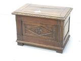 a small wooden box with a glass top on a white surface