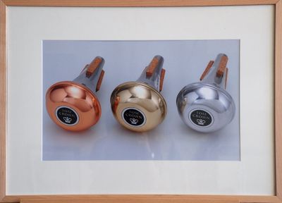 framed photograph of three different colored bells in a wooden frame