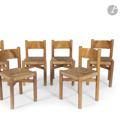 four wooden chairs with woven seats in a circle on a white surface