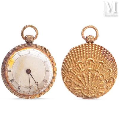 two gold pocket watches sitting side by side on a white surface