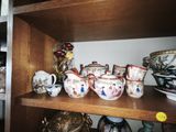 a wooden shelf with many different types of teapots on it