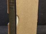 an open book sitting on top of a cardboard box on a table