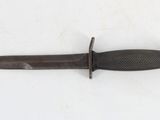 a knife that is laying on a white surface