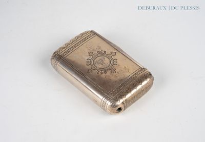 a small silver book sitting on a white surface