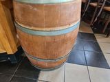 a large wooden barrel sitting on the floor in a restaurant
