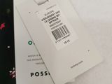 a tie with a tag attached to it on a bed