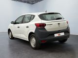 a white car parked in a room with a black floor
