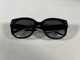 a pair of black sunglasses sitting on top of a table