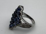 a close up of a silver ring with blue stones on it