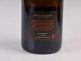 bottle of wine with a label on it sitting on a white surface