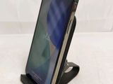a close up of a cell phone on a stand on a table