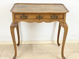 an old wooden table with a drawer on top of it