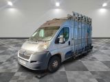 an image of a silver truck parked on a checkered floor