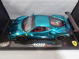a blue toy car in a black box on a table