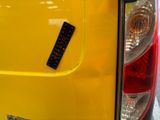 a sticker on the back of a yellow car