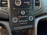 a car dashboard with a clock and a gear stick in it