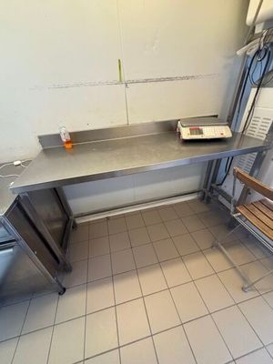 a bench and a table in a kitchen with tile flooring
