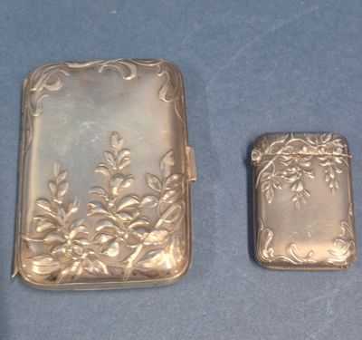 two silver lighters sitting next to each other on a blue surface