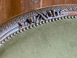 a close up of a chair with a green seat