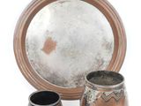 three different types of pottery sitting on a white surface