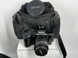 a black camera bag with a camera attached to it