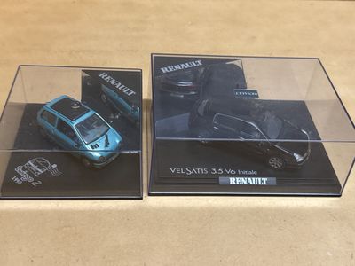 two models of a car in a display case
