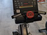 a row of stationary exercise bikes in a gym