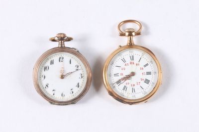 two gold pocket watches sitting side by side on a white surface