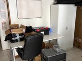 a desk with a chair and a computer on it in a room