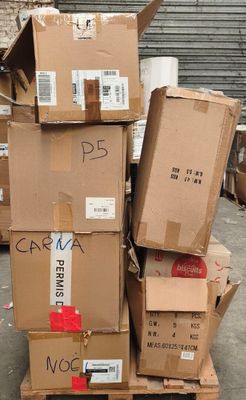 many boxes stacked on top of each other in a warehouse