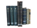 several old books are lined up on a shelf in front of a white background