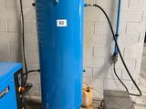 a blue tank sitting next to a blue machine in a room