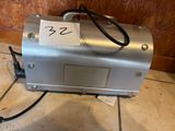a silver machine that is sitting on a tile floor