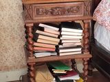 a wooden table with a bunch of books on top of it