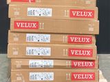 several boxes of veluxx are stacked on a pallet in front of a black wall