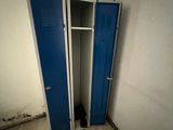a blue door in a white room with a wooden floor
